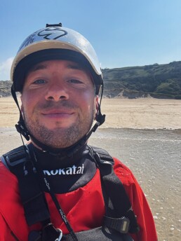 James Roberts sea kayak coach on a Cornish beach in paddling gear