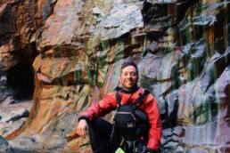 James Roberts sea kayak coach in a Cornish cave in paddling gear