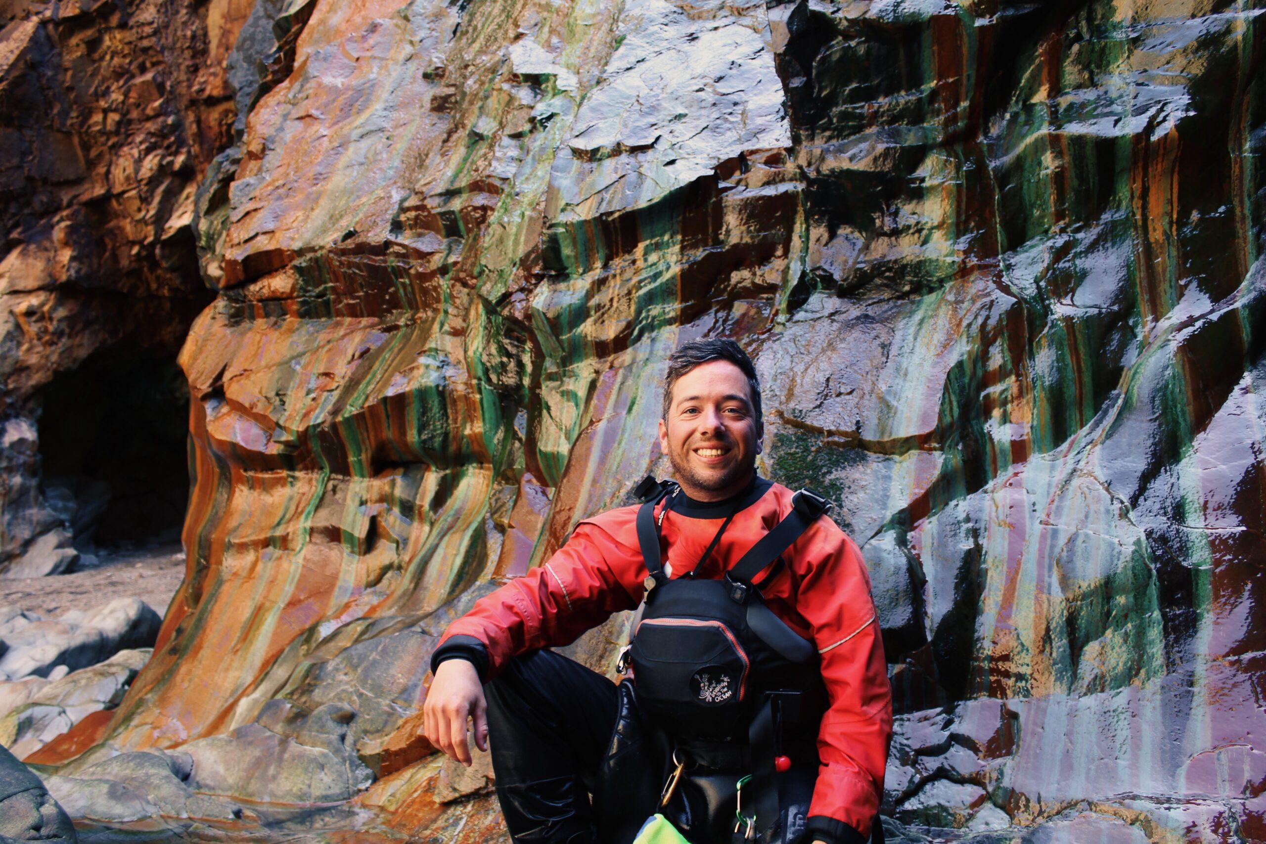 James Roberts sea kayak coach in a Cornish cave in paddling gear