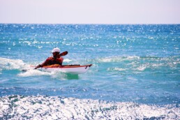 James Roberts Sea kayak Coach Surfing a small wave at Para Sands beach