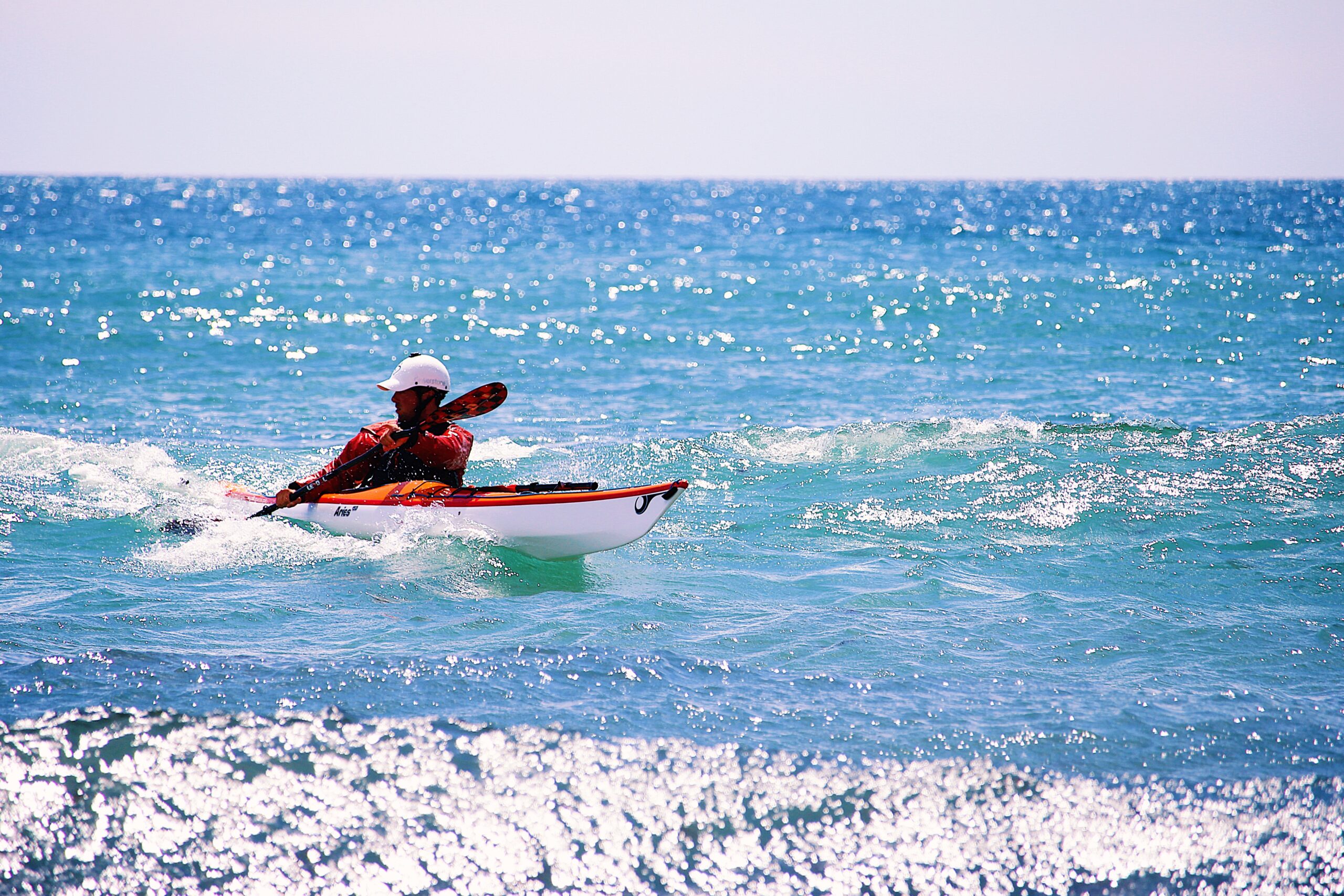 James Roberts Sea kayak Coach Surfing a small wave at Para Sands beach