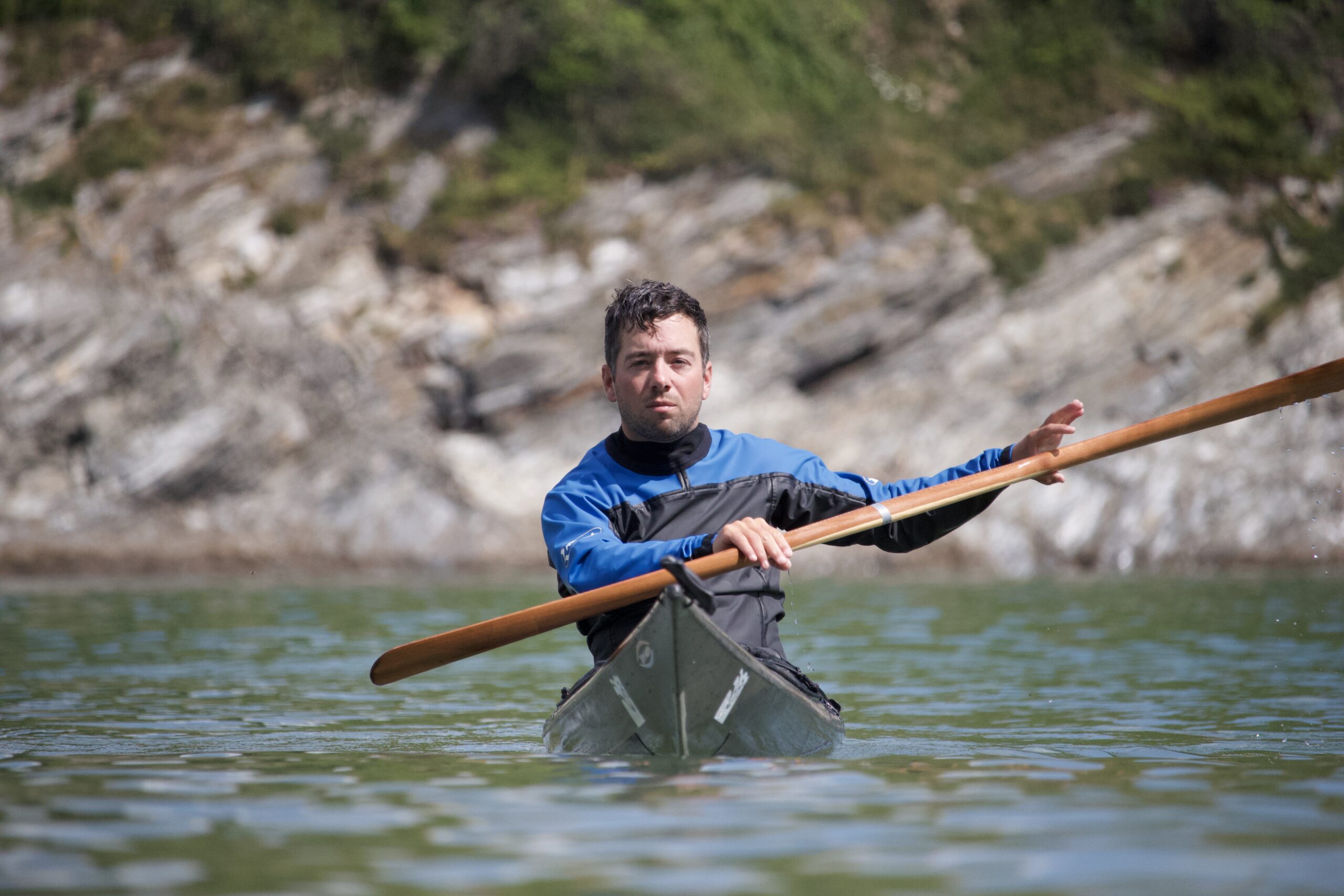 James Roberts Sea Kayak Coach Paddling a low volume Greenland Kayak on a Cornish Beach